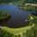 a lake with trees and grass