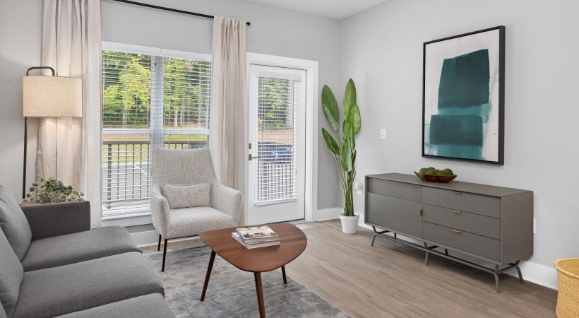 Wide open living areas flooded with natural light a living room with a couch, tables and a chair
