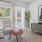 a living room with a couch, tables and a chair