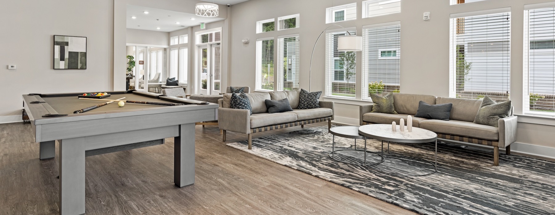 a clubroom with a pool table and couches