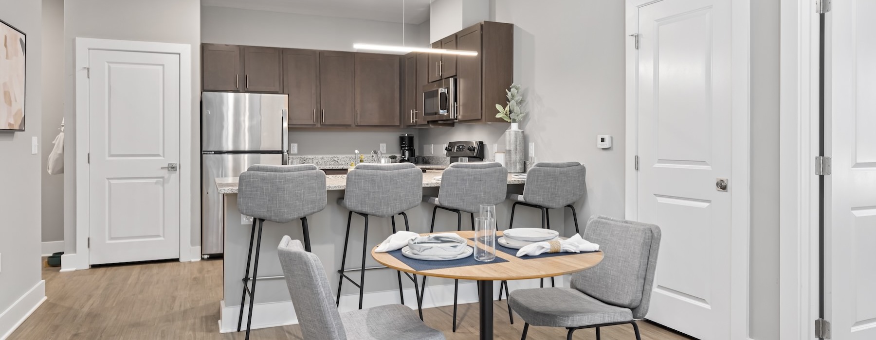 a kitchen with a dining table and chairs