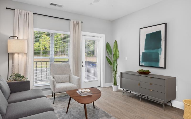 a living room with a couch, tables and a chair