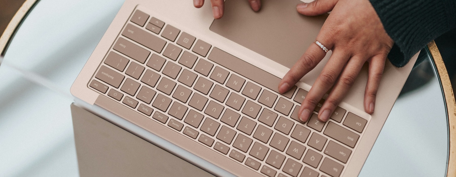a person sitting at a table with a laptop