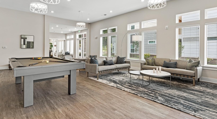 Cutting-edge amenities at your fingertips a clubroom with a pool table and couches